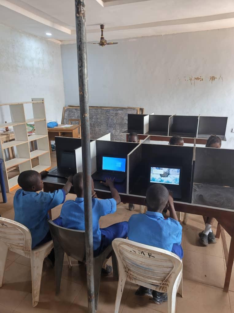 Pupils working at laptops in the Sound Mind Schools computer room